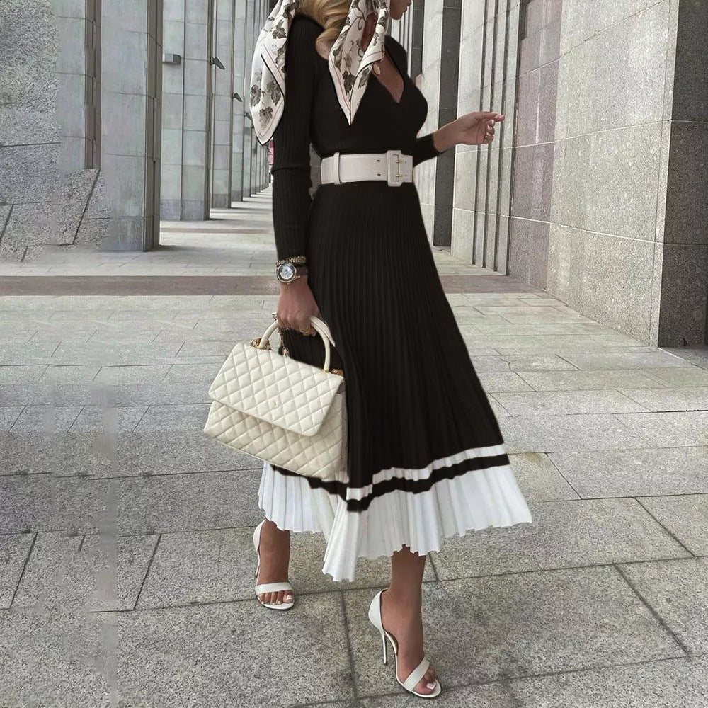 allvariants:: Woman in a stylish outfit with a black and white dress, holding a white handbag, walking on a city street.