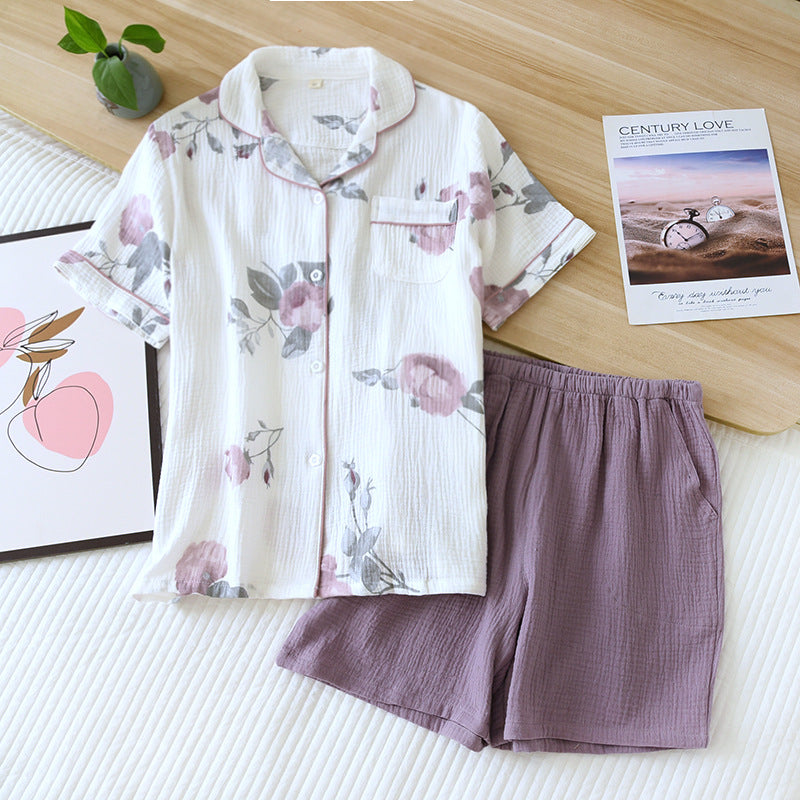 allvariants:: Floral pajama set with purple shorts on a bed with magazines.