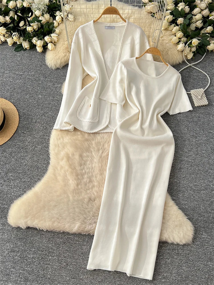 allvariants:: White dress with cut-out design on a hanger against a neutral background