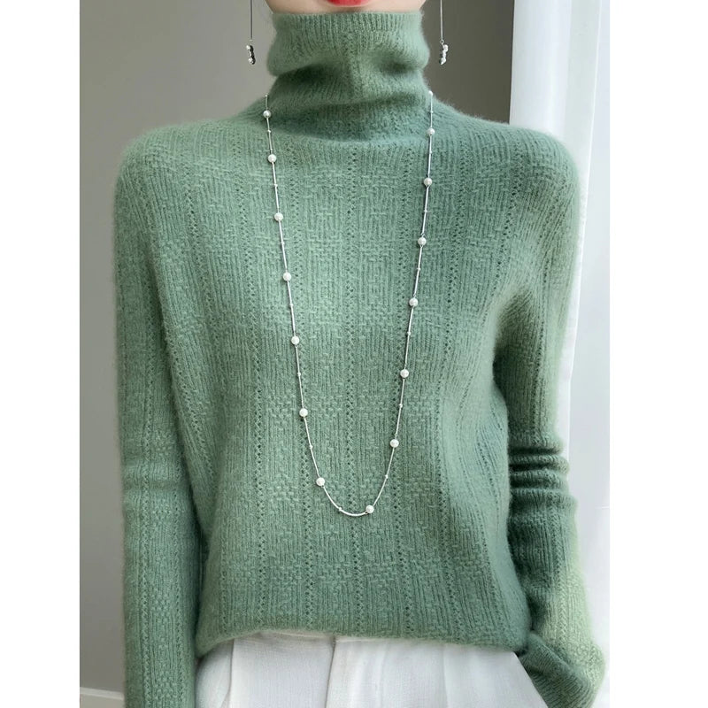 allvariants:: Green turtleneck sweater worn by a person with a pearl necklace.
