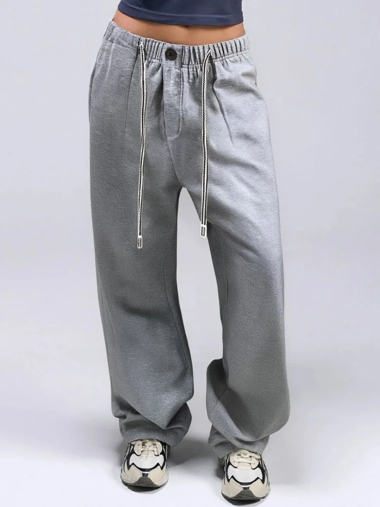 allvariants:: Gray baggy pants worn by a person on a white background