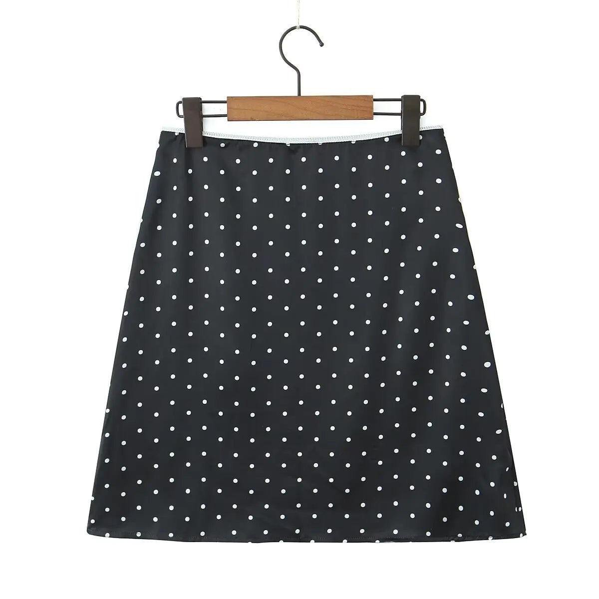 black::Black polka dot skirt on a hanger against a white background