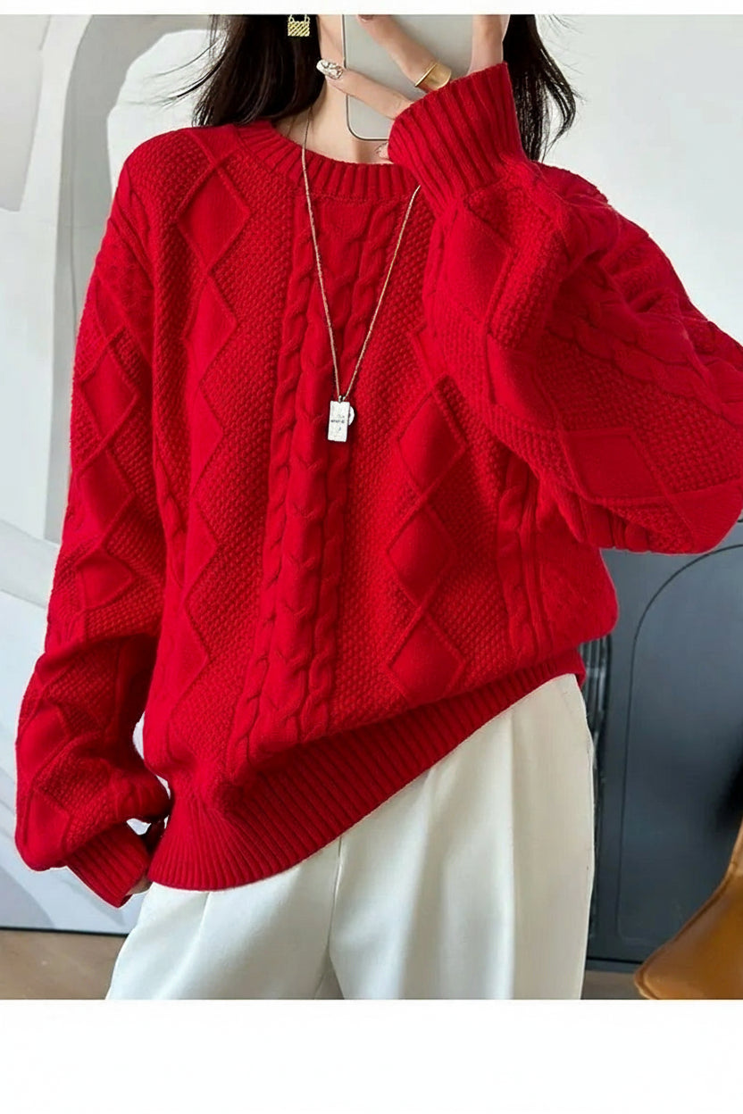 Person wearing a red knitted sweater with a blurred background