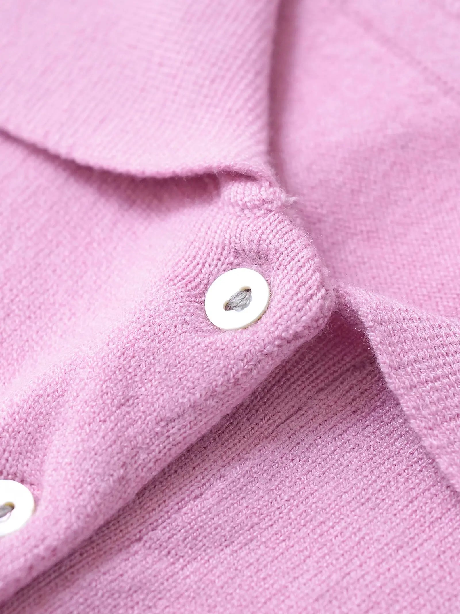 pink::Close-up of a pink textured fabric with buttons