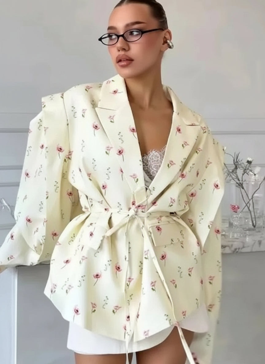 allvariants:: Woman wearing a cream-colored floral robe against a neutral background