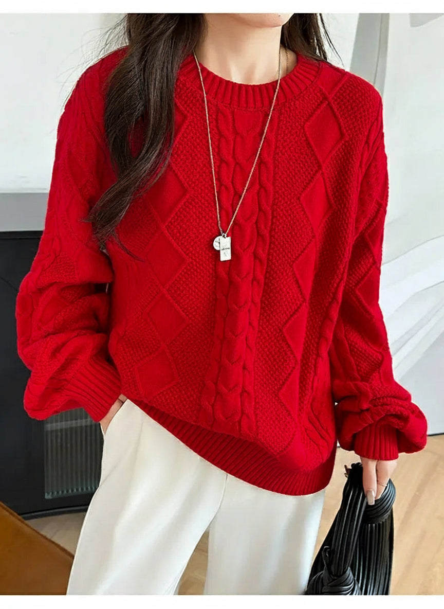 red:: Person wearing a red cable knit sweater with a neutral background