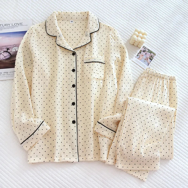 allvariants:: Beige polka dot pajama set on a textured white surface with magazines underneath.
