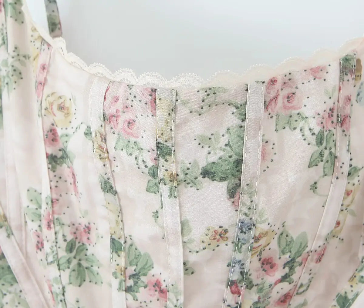 cream::Floral patterned fabric with pink and green colors on a light background