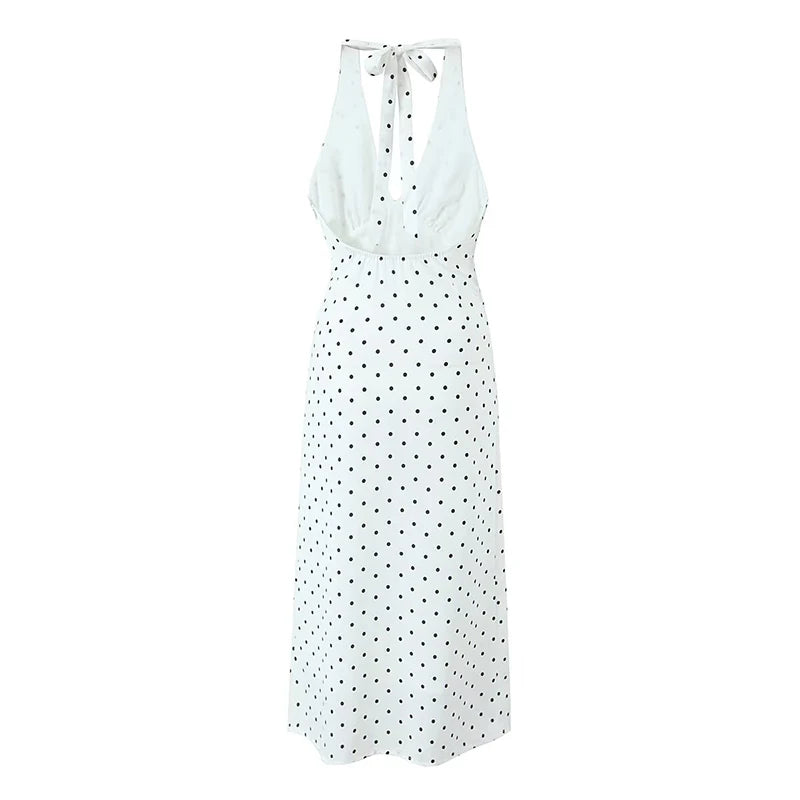 white::White sleeveless dress with black polka dot pattern on a white background