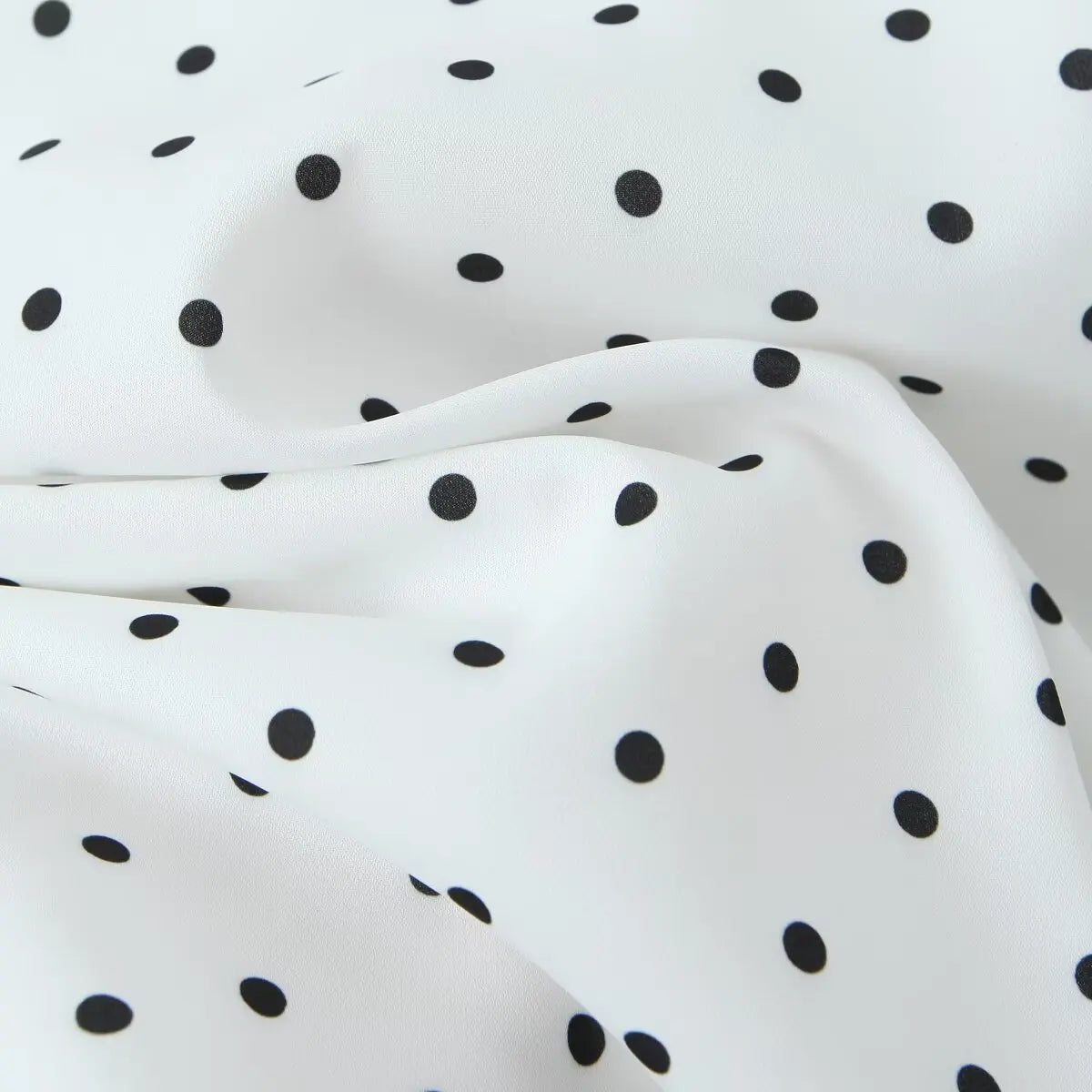 white::White fabric with black polka dot pattern