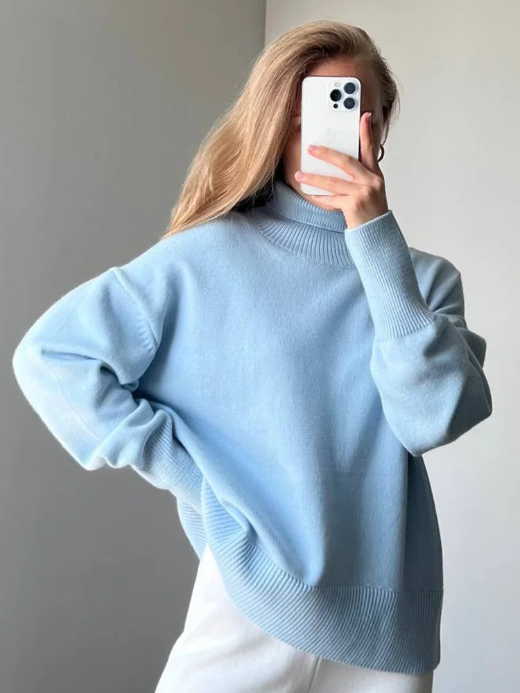 allvariants:: Person wearing a light blue sweater taking a mirror selfie.