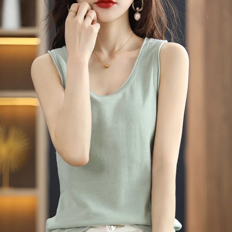 allvariants:: Woman wearing a light green sleeveless top with a blurred background