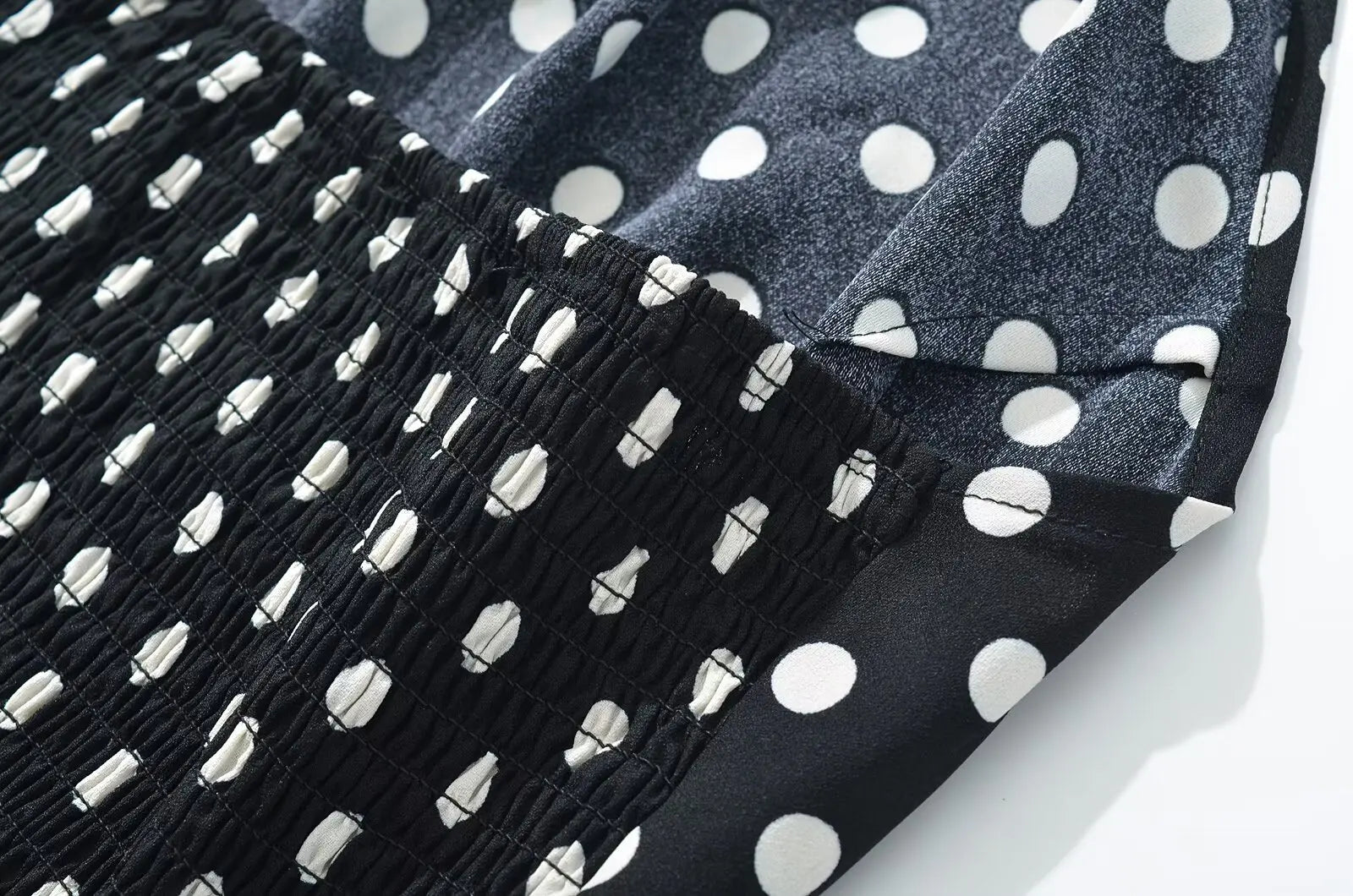 black::Black and white polka dot fabric with fringe on a white background