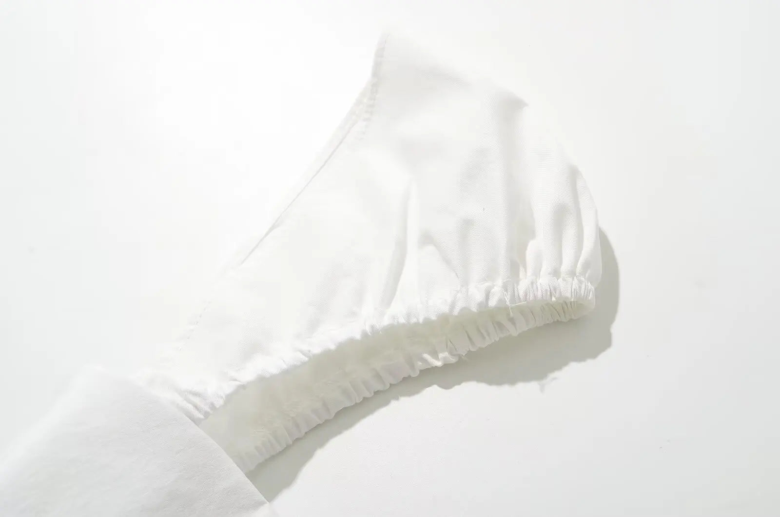 white::Close-up of a white sock on a light gray background