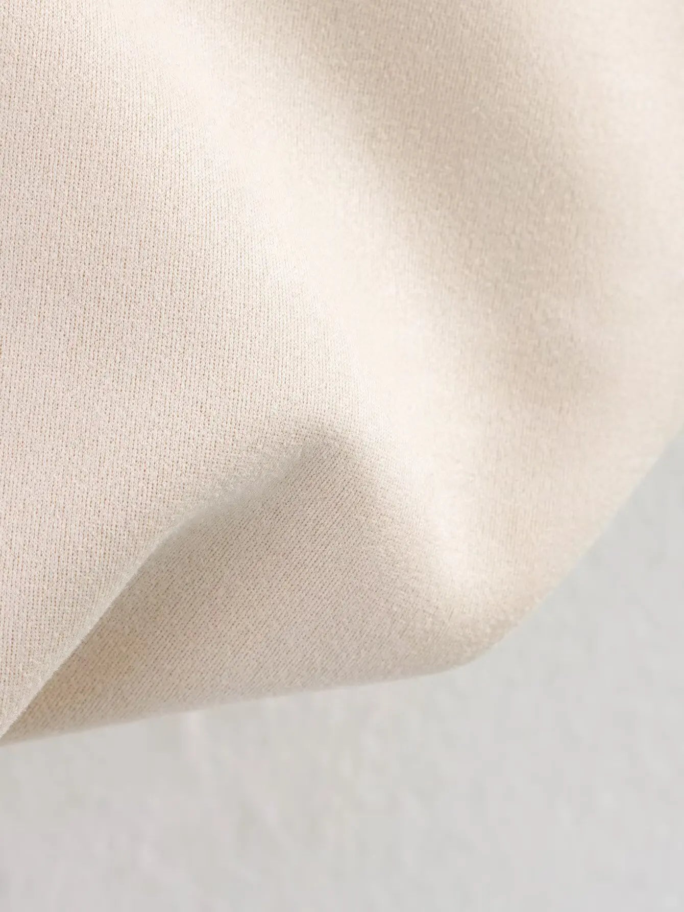 allvariant::Close-up of beige fabric texture on a light gray background