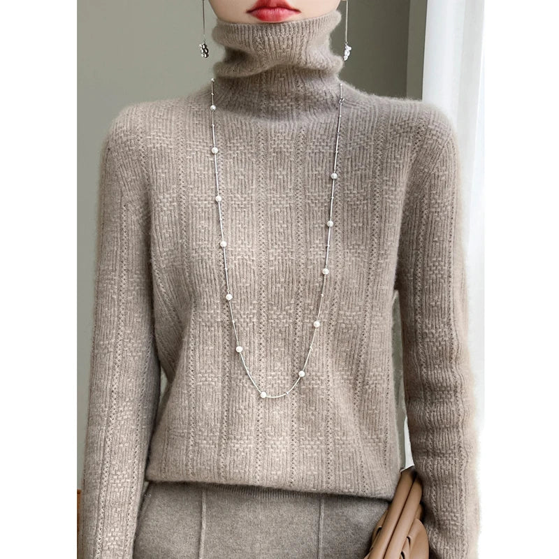 allvariants:: Person wearing a gray turtleneck sweater with a long pearl necklace.