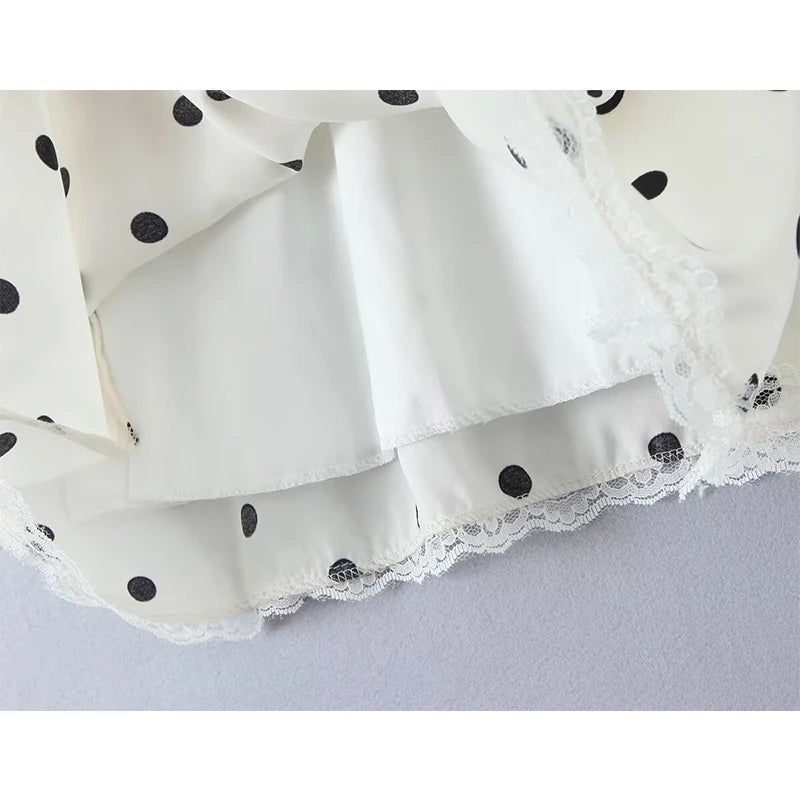 white::White fabric with black polka dots and lace trim on a light gray background