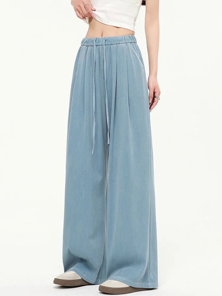 allvariants:: Light blue wide-leg pants worn by a person on a white background
