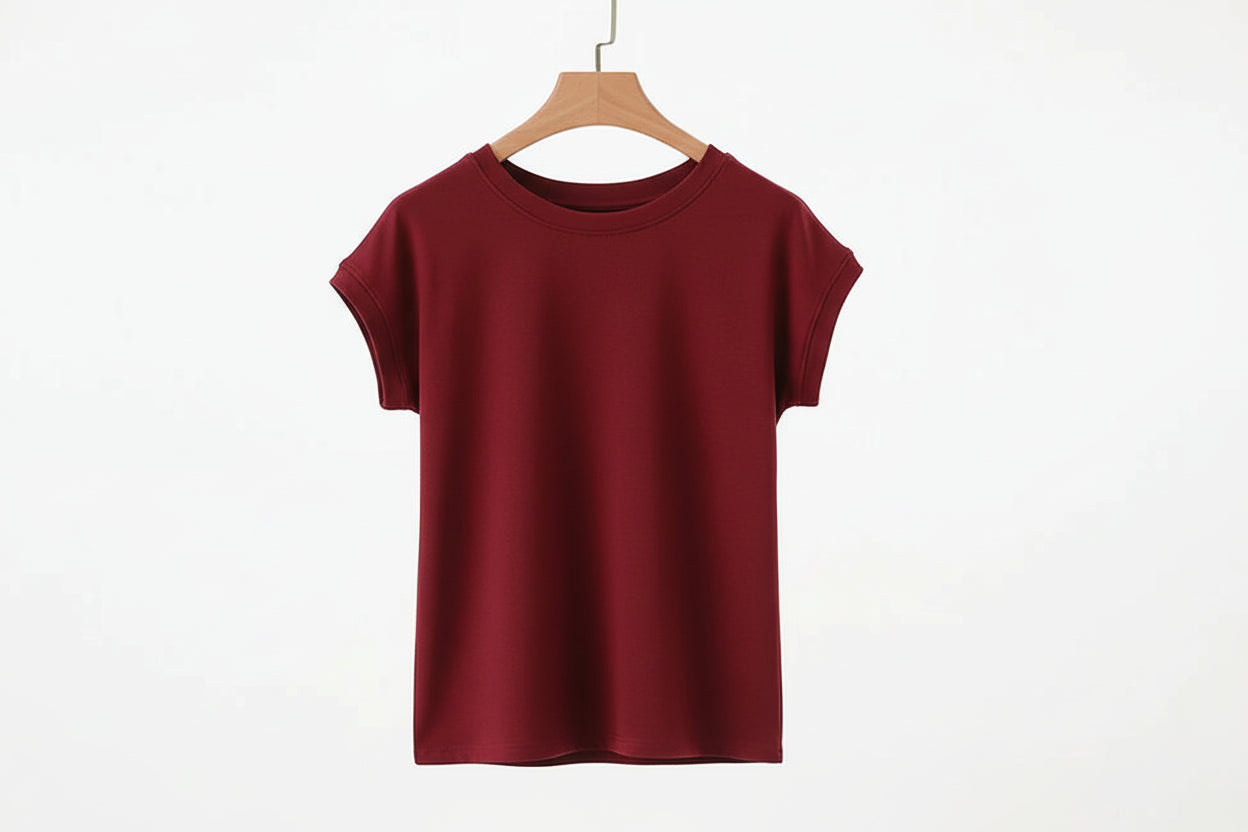 allvariants:: Red t-shirt on a hanger against a white background