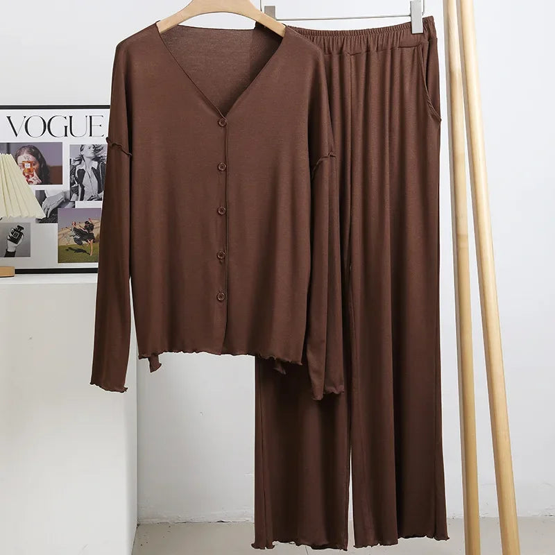 allvariants:: Brown outfit with top and pants on a hanger against a white wall.