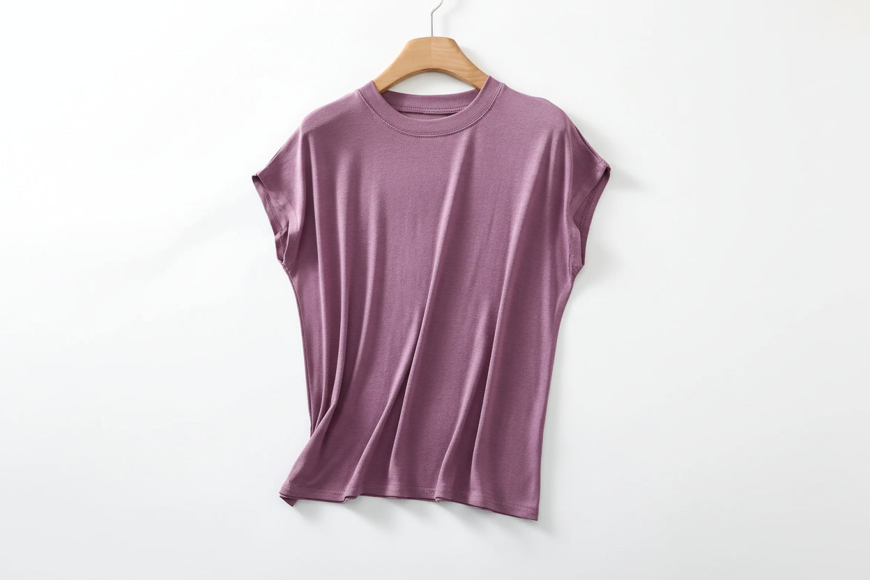 allvariants:: Purple t-shirt on a wooden hanger with a magazine and coffee beans in the background