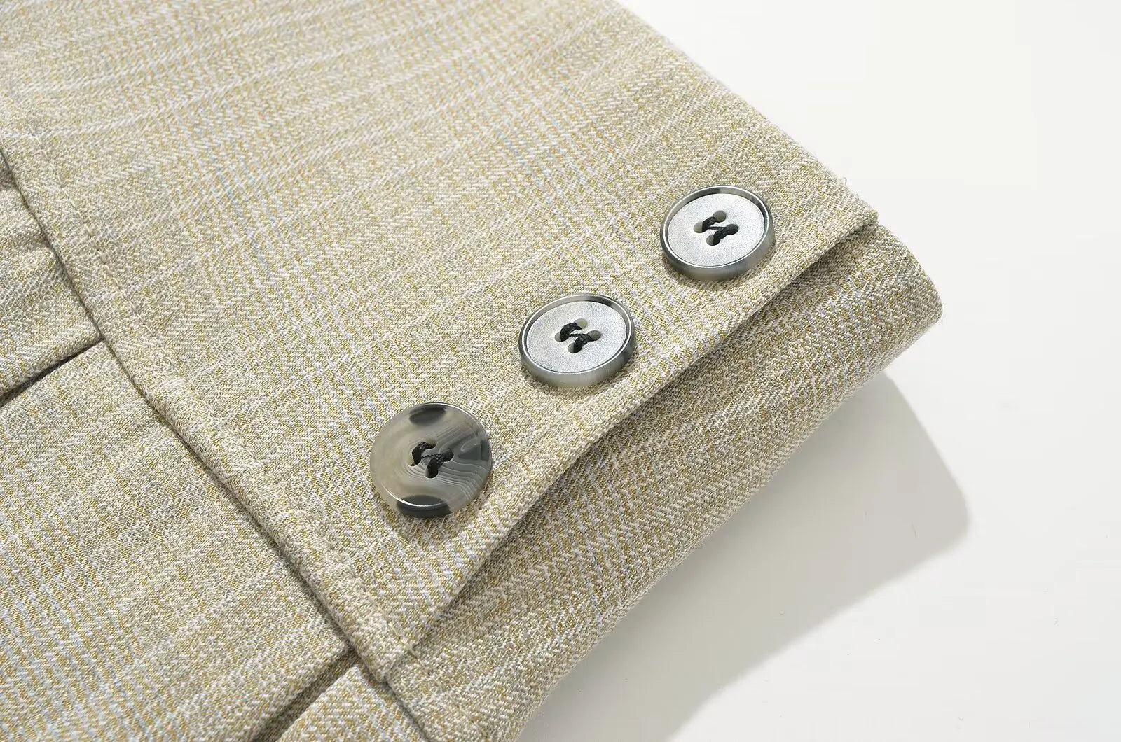 allvariant::Close-up of a beige textured fabric with buttons on a white background