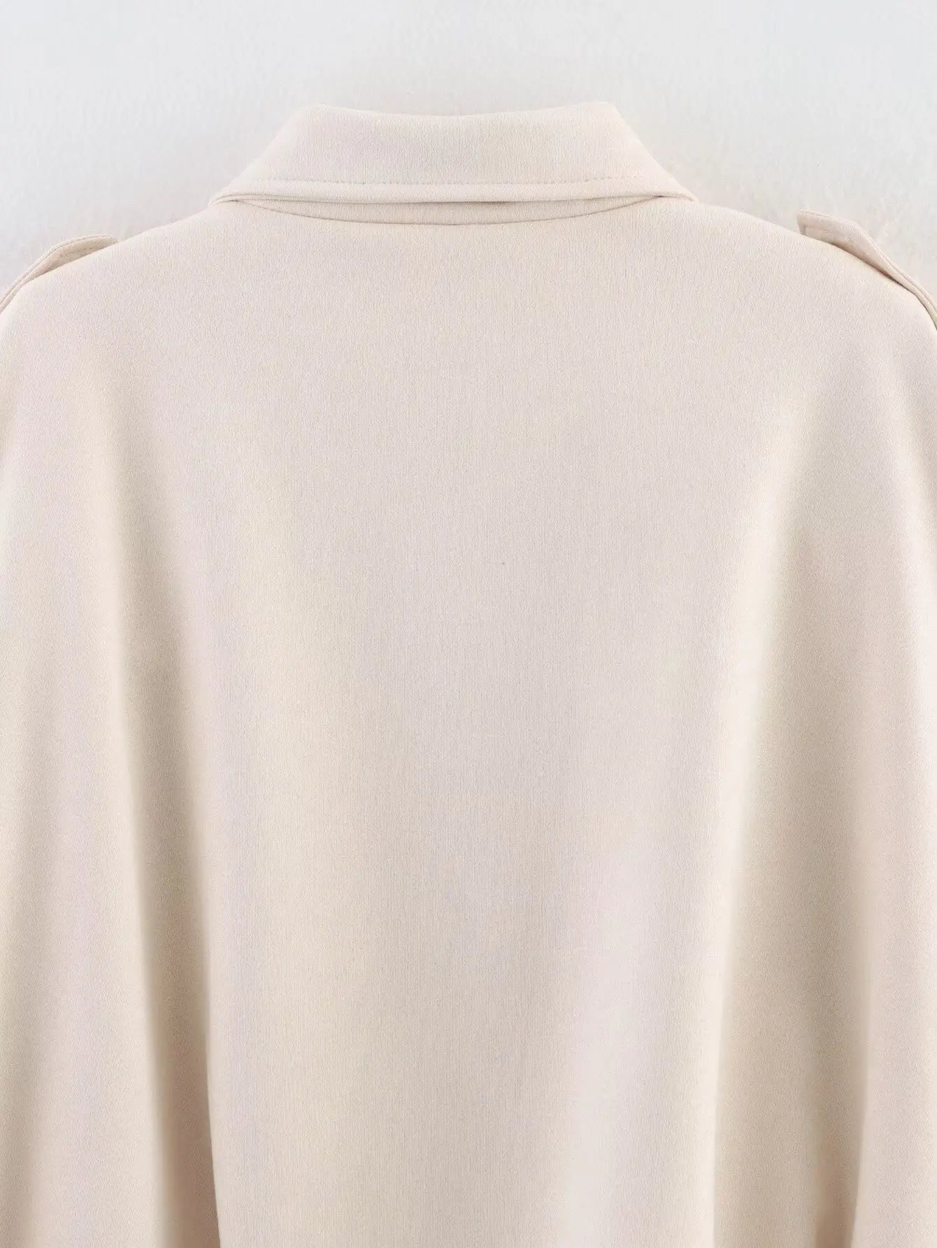 allvariant::Close-up of a beige jacket on a white background