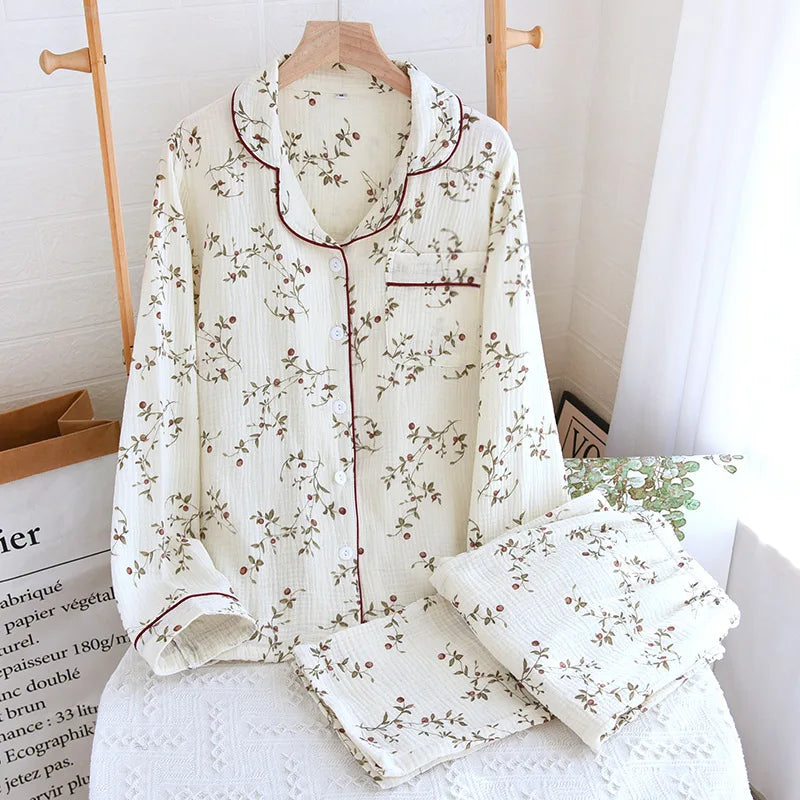 White:: Floral-patterned pajama set on a mannequin with matching pillowcase in a cozy room setting.