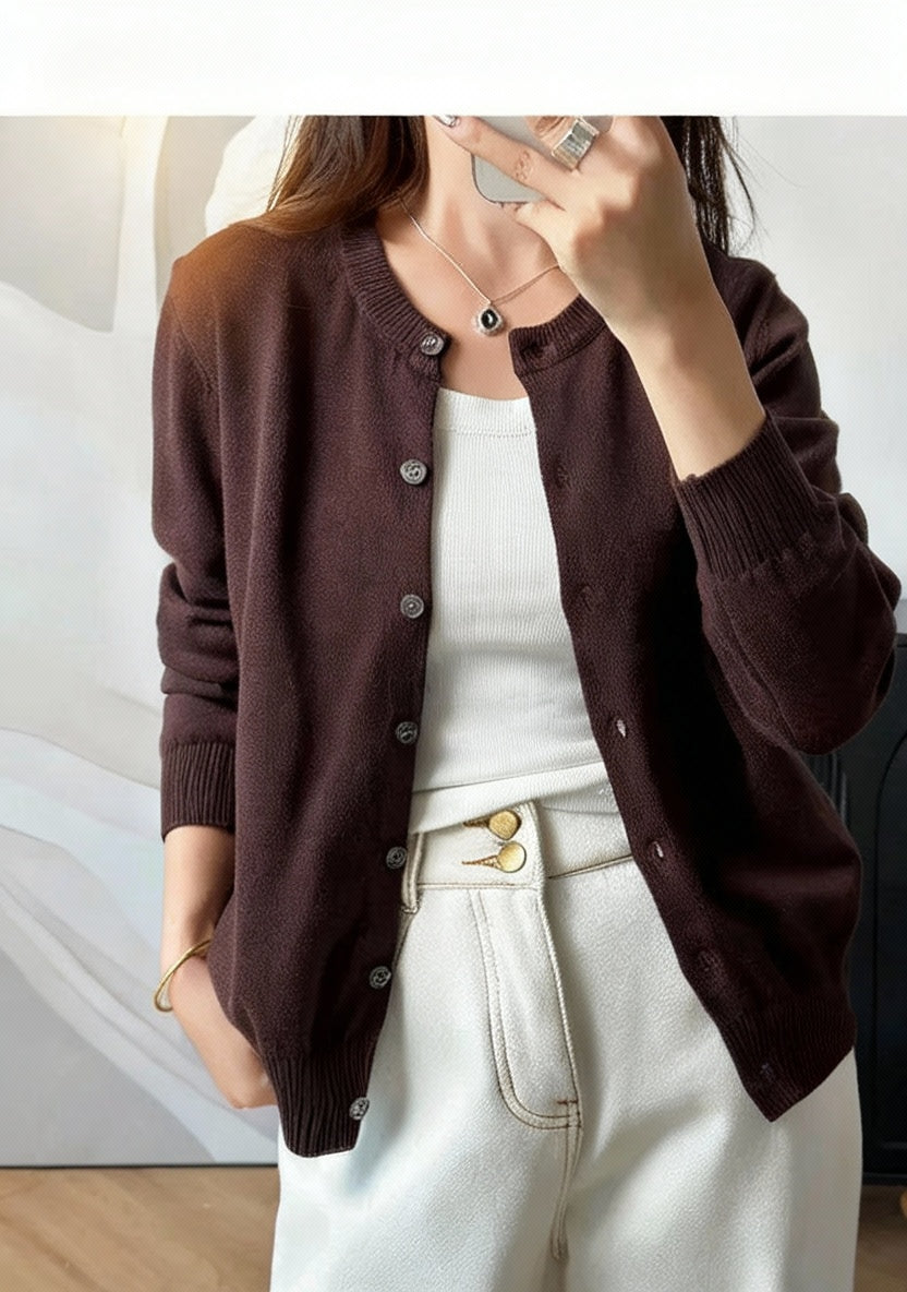 Coffee:: Person wearing a brown cardigan over a white top and light blue jeans, with 'INTELLECTUAL' text on a white background.