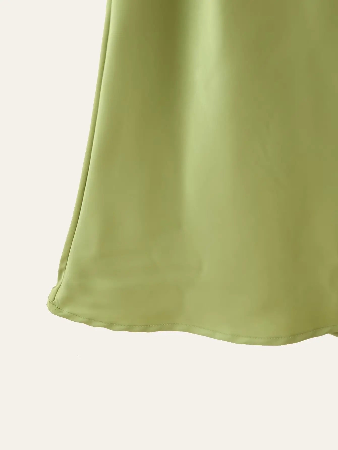 Green::Close-up of a light green fabric texture on a white background