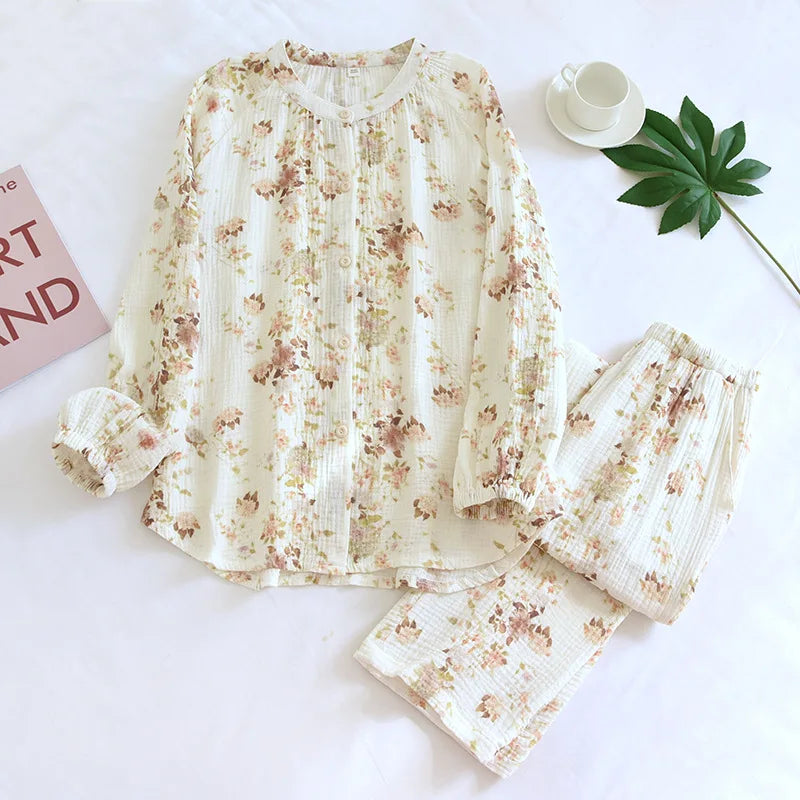 allvariants:: Floral pajama set on a white surface with a cup and saucer, book, and leaf decoration.