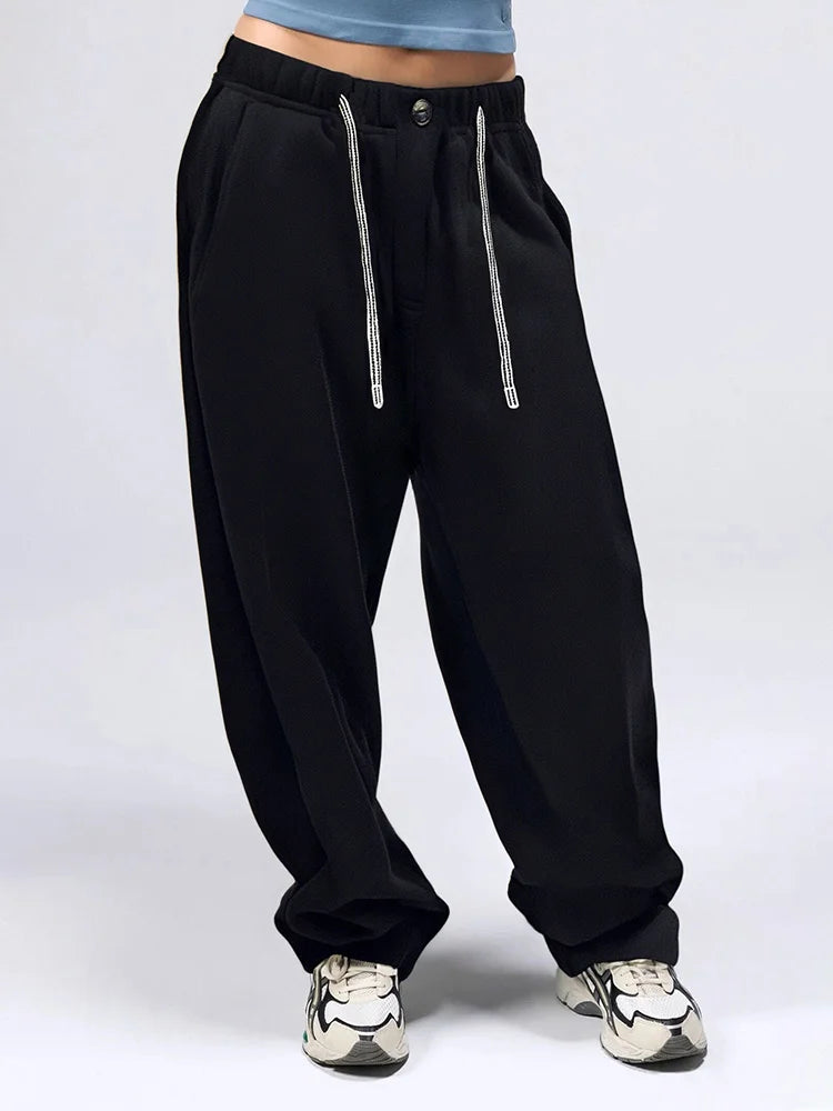 allvariants:: Black baggy pants with silver zippers on a light gray background
