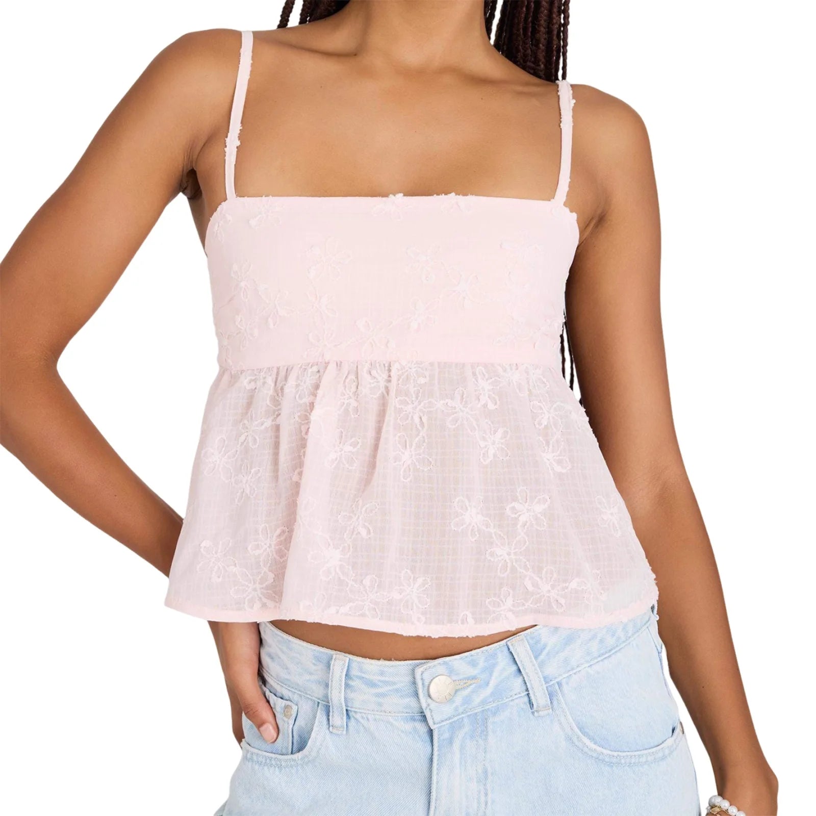 allvariants:: Woman wearing a light pink top and light blue jeans on a white background