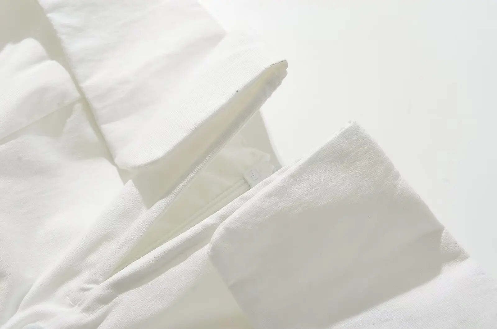 white::Close-up of white pillows on a light gray background