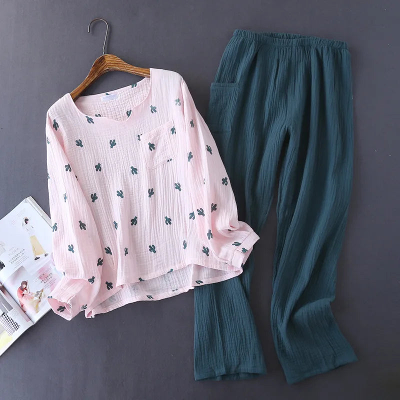 allvariants:: Pink floral top and teal pants on a hanger against a gray background