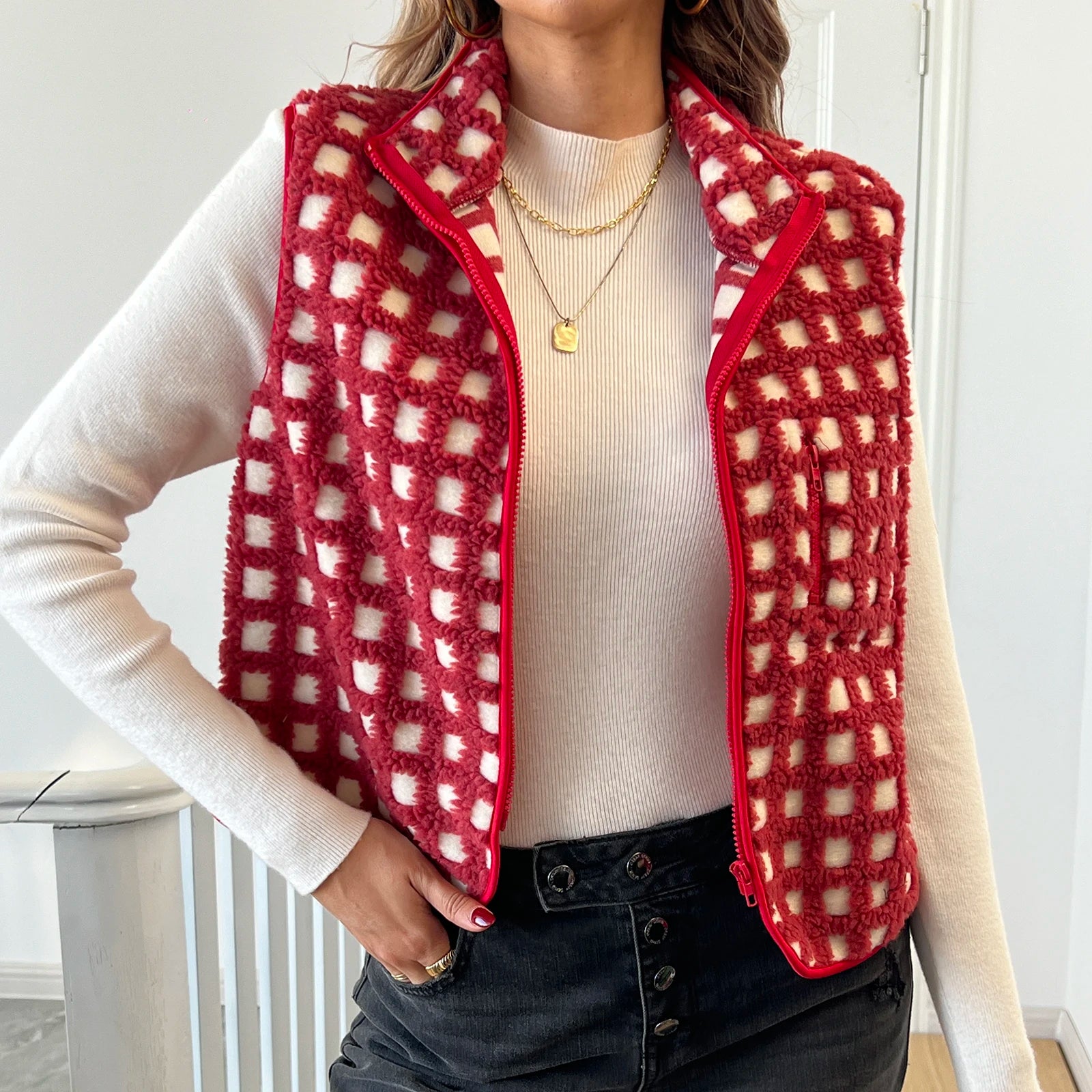 allvariants:: Person wearing a red and white checkered vest over a white shirt.