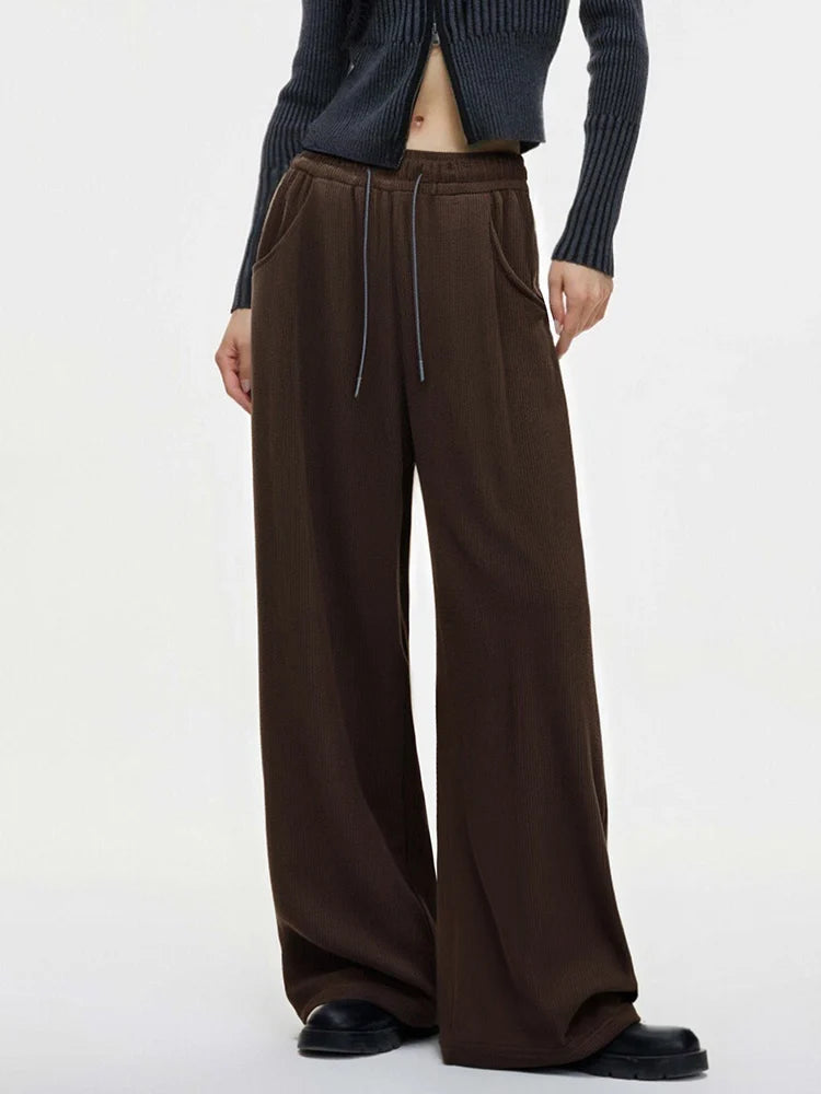 allvariants:: Brown wide-leg pants worn by a person on a white background