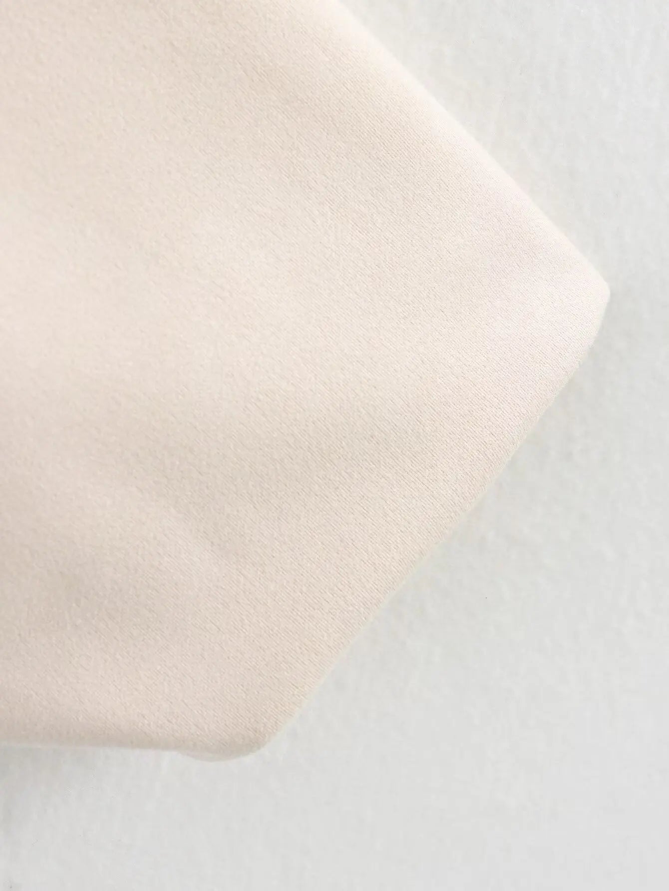 Close-up of a light pink fabric on a gray background