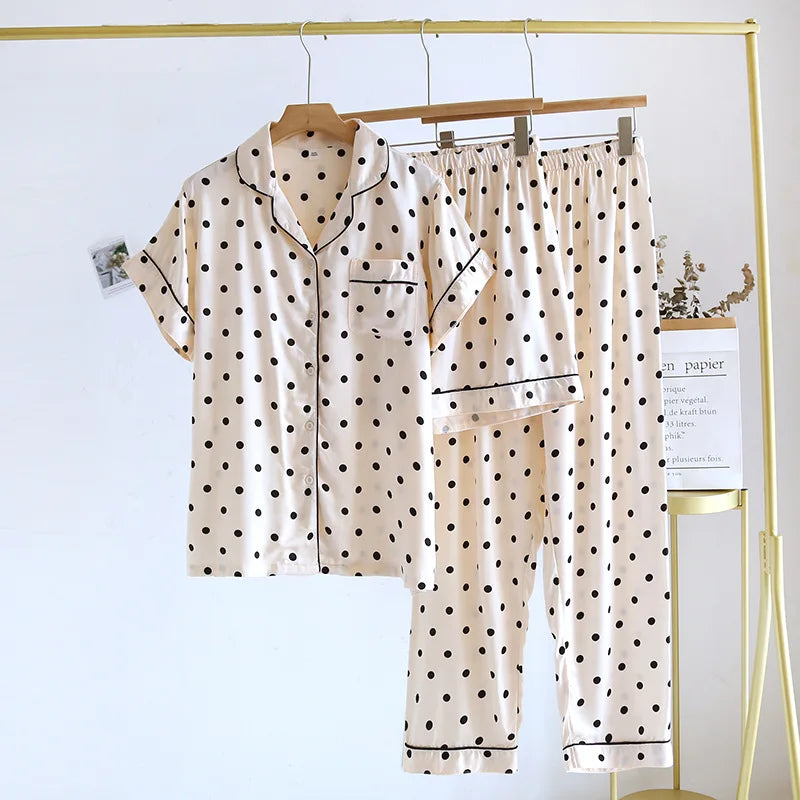 allvariants:: Polka dot pajama set hanging on a rack against a white background
