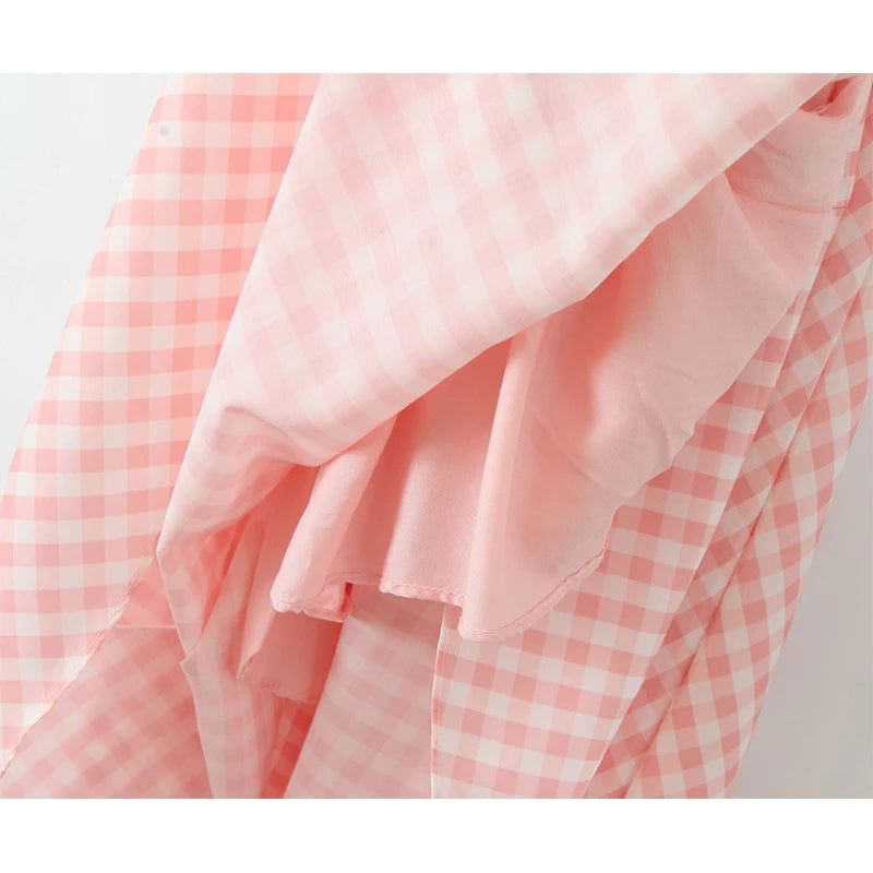 pink::Close-up of pink and white checkered fabric on a light gray background
