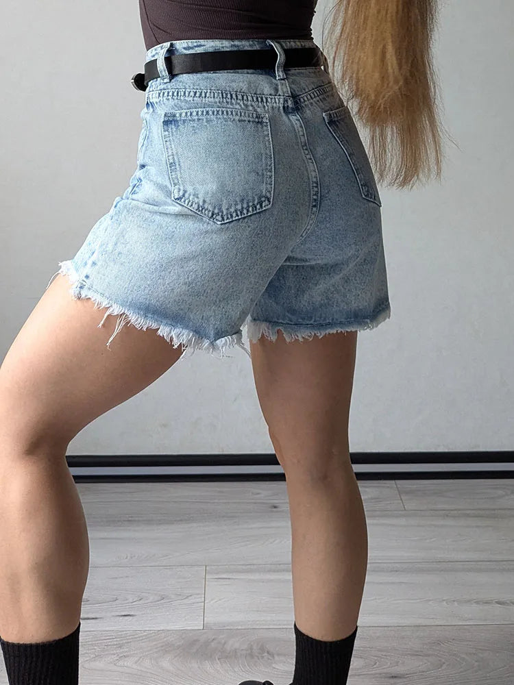 Light Blue:: Person wearing light blue denim shorts on a plain background