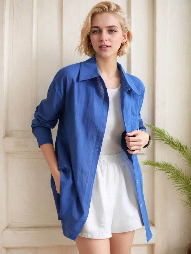 allvariants:: Woman wearing a blue shirt over a white dress in a neutral setting