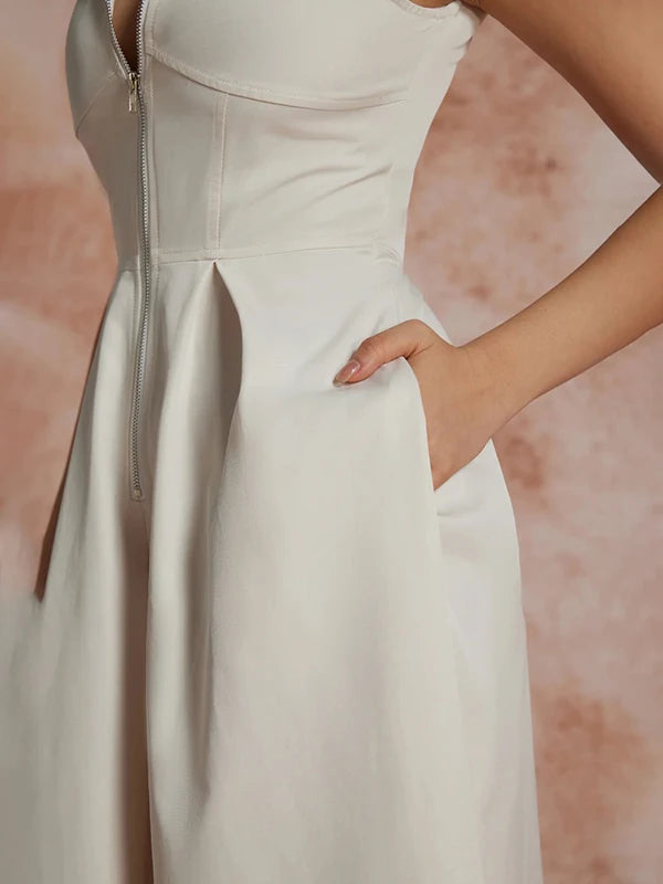 White:: dress with a zipper detail on a pink background