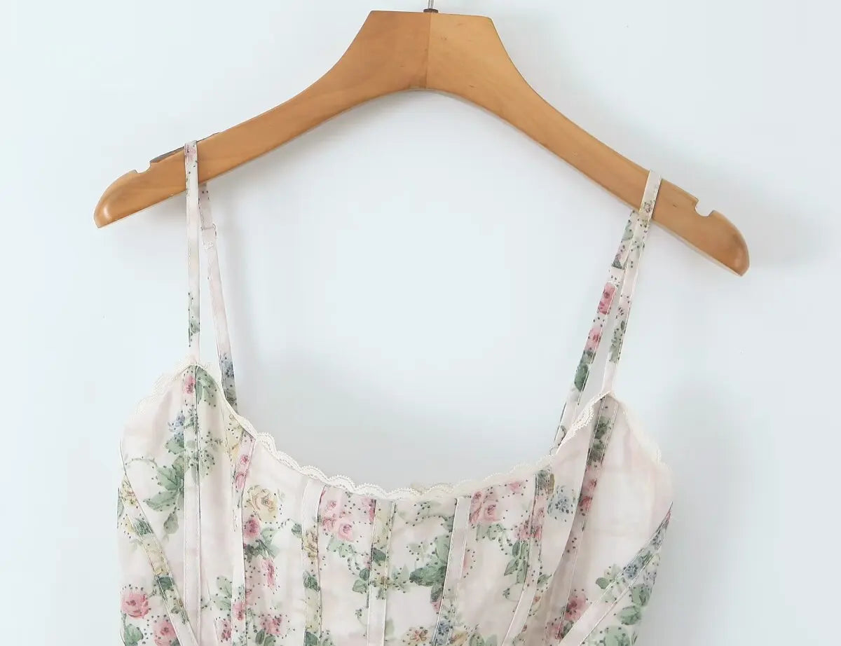 cream::Floral dress on a wooden hanger against a white background