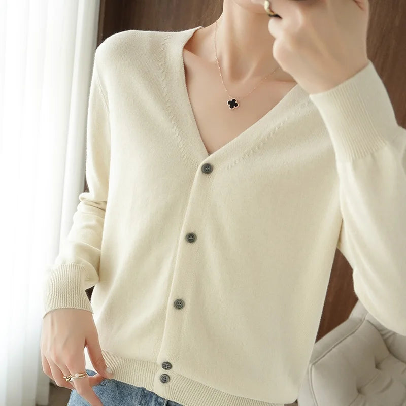 allvariants:: Person wearing a cream-colored cardigan with a blurred background