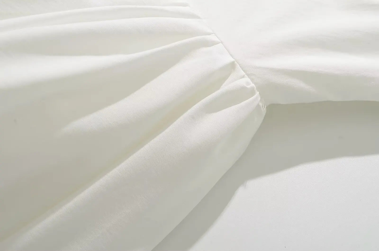 white::Close-up of white fabric with folds