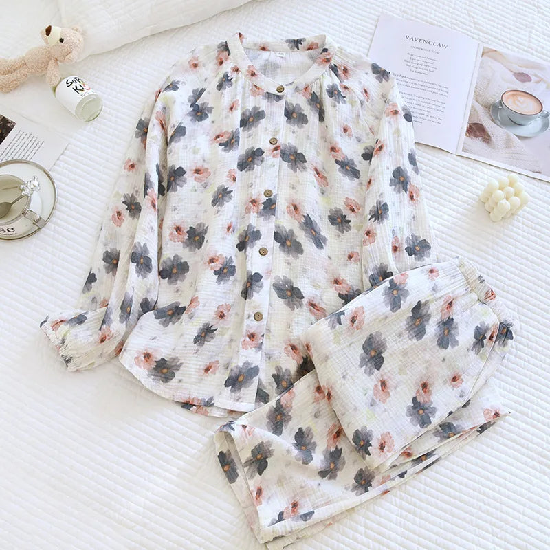 allvariants:: Floral pajama set on a textured surface with a cup and teddy bear in the background