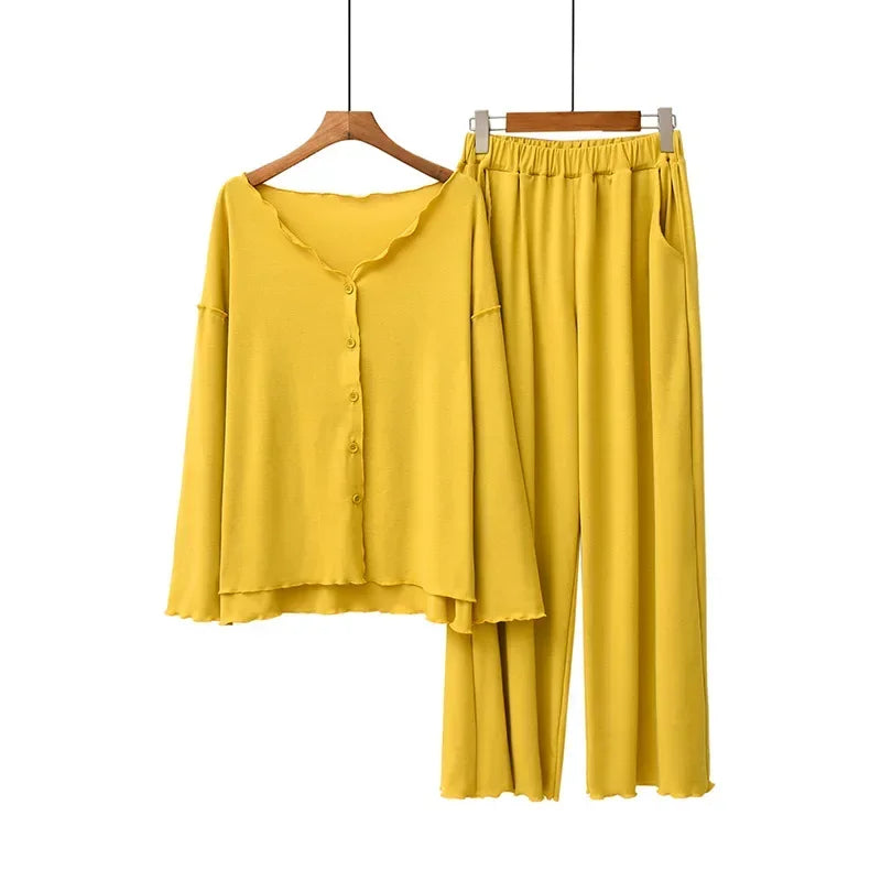 allvariants:: Yellow shirt and pants set on hangers against a white background
