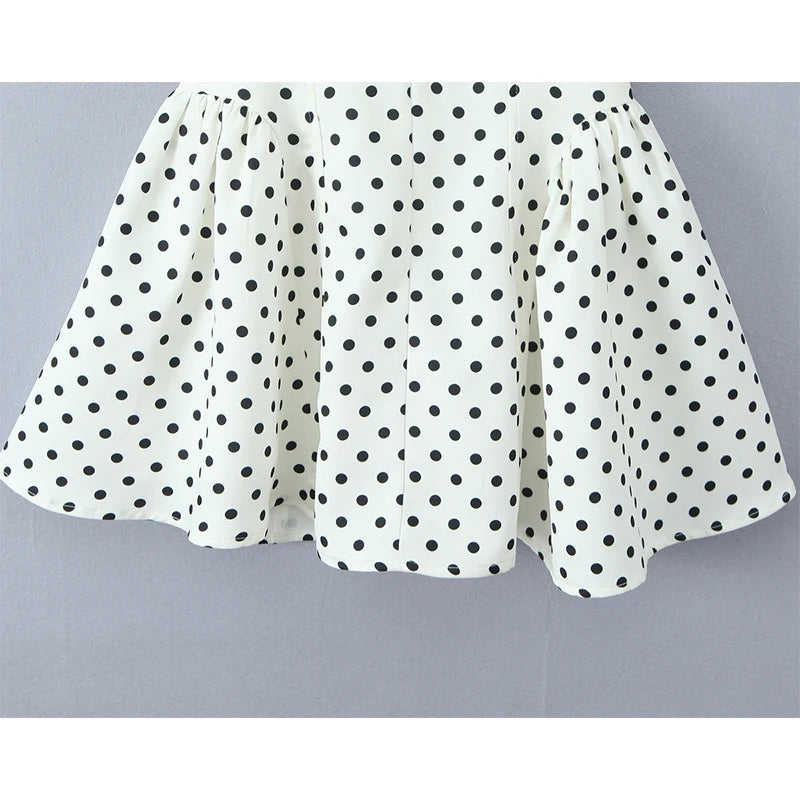 white::White skirt with black polka dots on a gray background