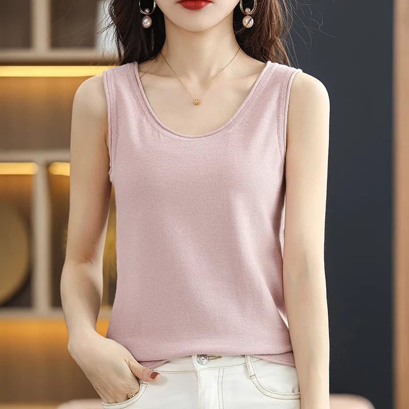allvariants:: Woman wearing a pink tank top with a blurred background